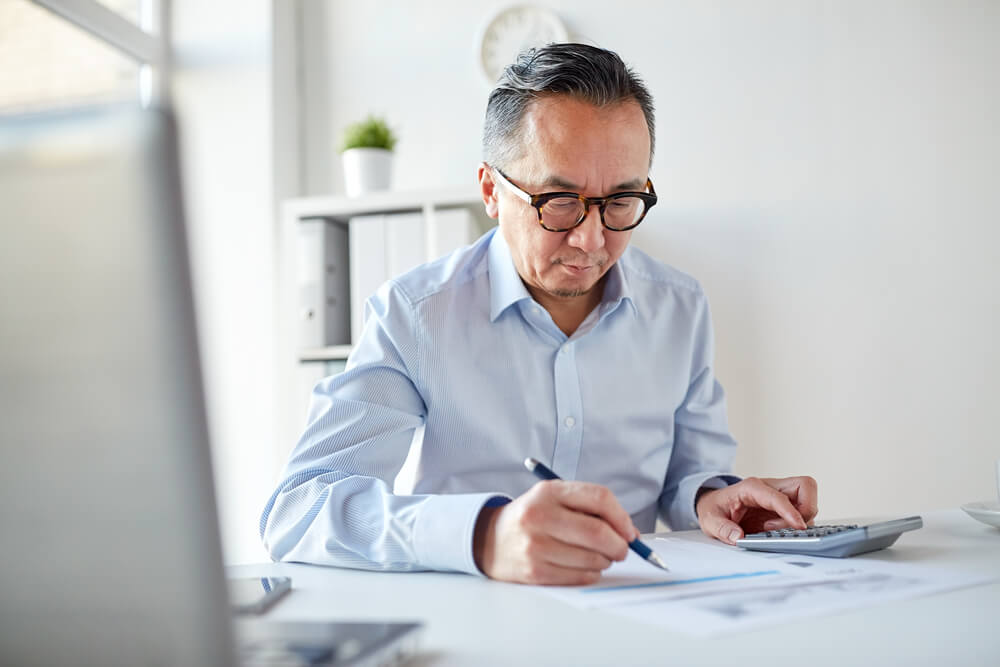 businessman with calculator and paper working in office