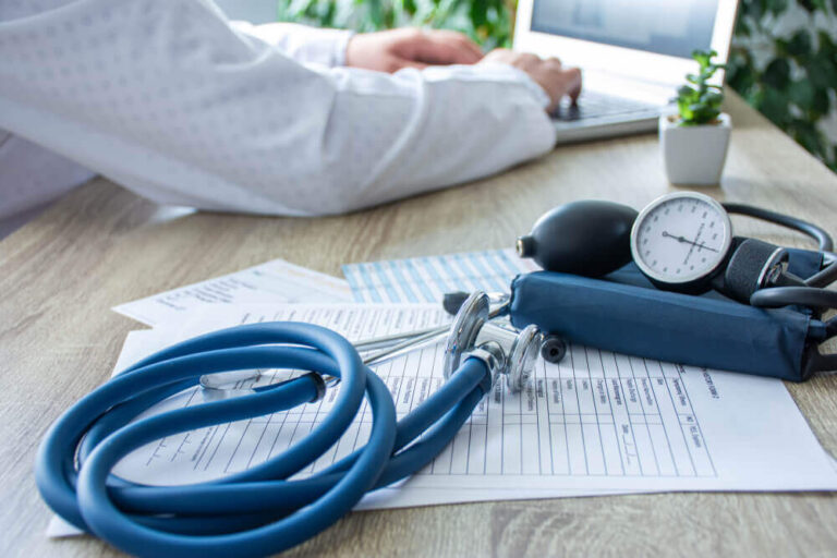 a stethoscope with sphygmomanometer on medical documents on the table