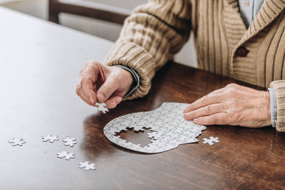 Senior man playing with puzzles