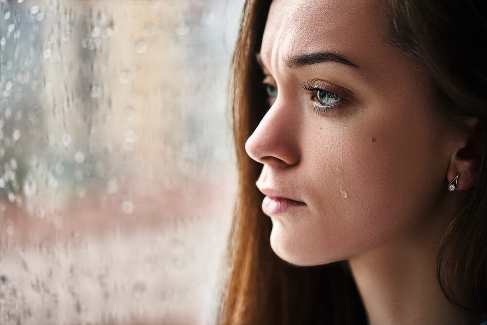 Sad upset crying woman with tears eyes