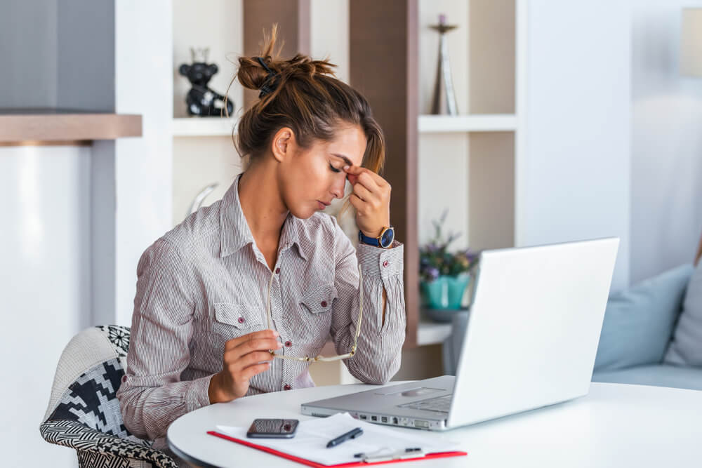 Young frustrated woman working at office