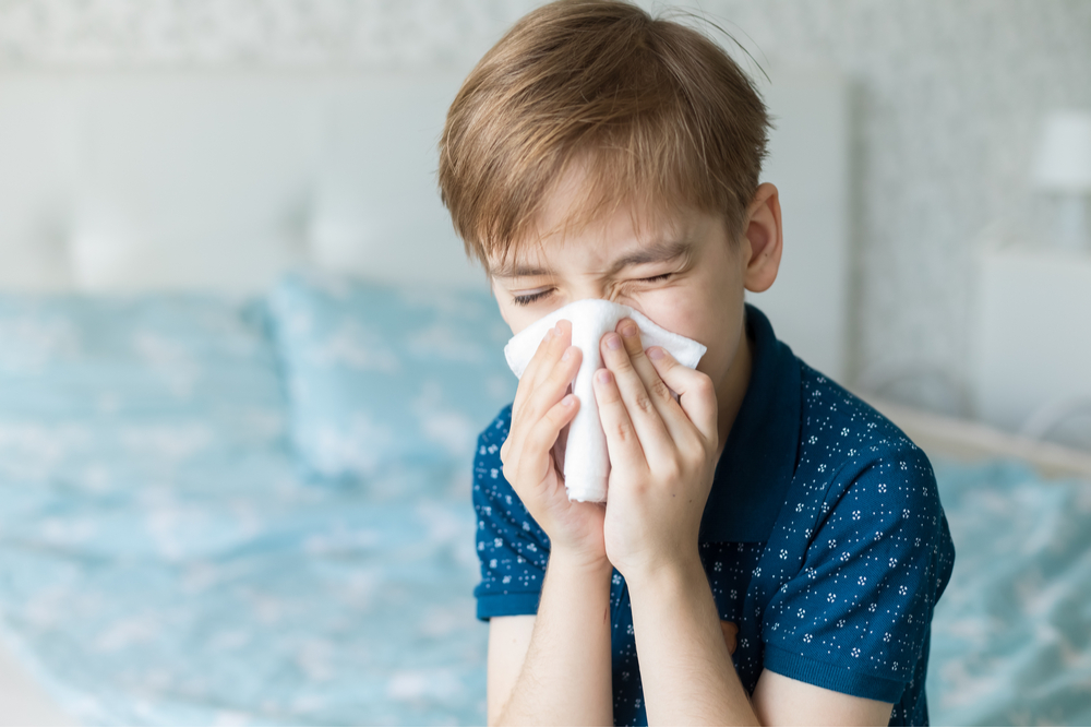 Boy suffers from a runny nose and allergic reactions