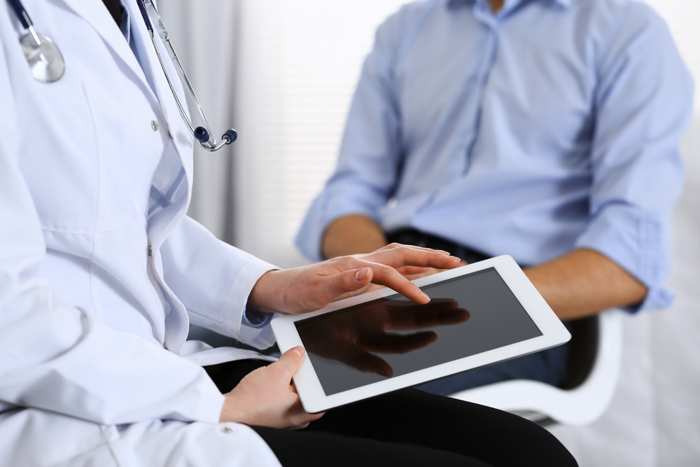 Doctor with patient discussing their Adult Primary Care options