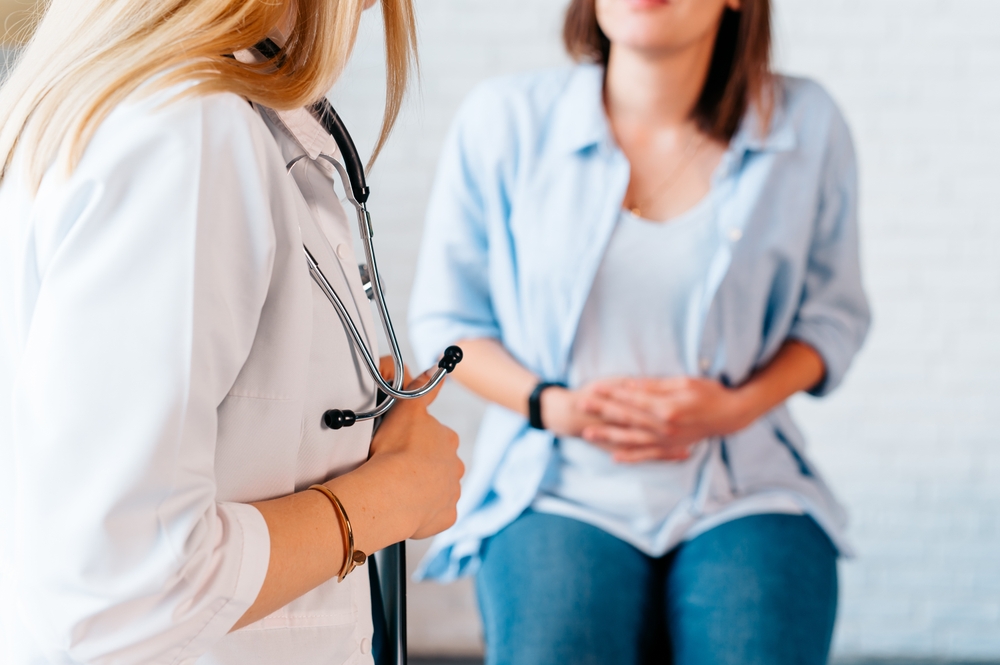 A doctor talking with a patient about Women's Health services